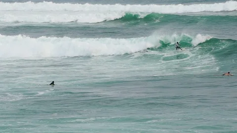 SRI LANKA - CIRCA 2017: Young surfers learn to ride the waves. Evening ocean Stock-Footage 84778700