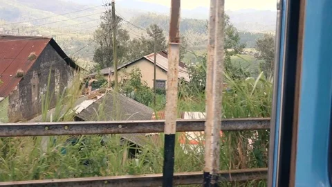 Sri Lanka - View from train moving through mountain village Stock Footage 73424494