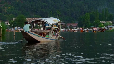 SRINAGAR  INDIA  MAY 19 2026 Local people rowing boats through Dal Lake Stock Footage 336480064