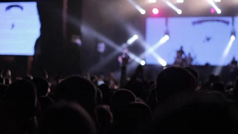 Сrowd clapping by the hands at the concert. Silhouettes of the people. Blury Stock Footage 80352062