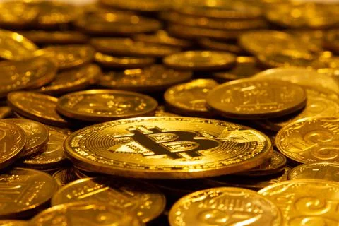 Сryptocurrency Bitcoin against the background of other gold coins in soft light Stock Photos