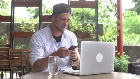 Сryptocurrency trader making bargain using smartphone and laptop Stock Footage 84923279