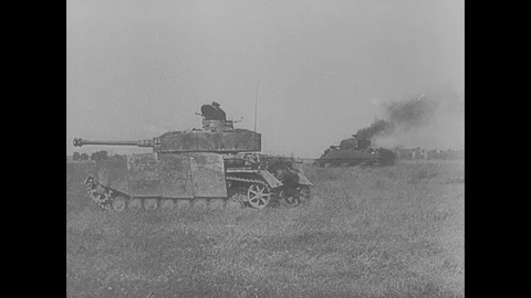 SS troops pass destroyed Allied tanks and burning building Stock Footage 103380413