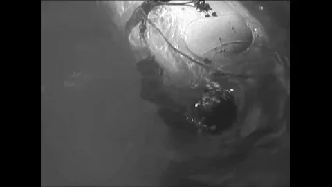 The SSB attaches to the side of a merchant ship and one operator connects a Stock-Footage 88608032