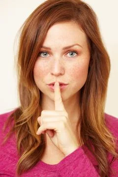 Ssh..you didnt hear it from me. Portrait of a beautiful young woman with her Stock Photos