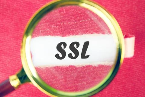 SSL Secure Sockets Layer through a magnifying glass under a torn piece of pap Fotos de archivo