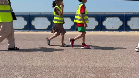 St Annes Beach, UK 2025 July 13:   School children in hi-vis gilet. 4k video Stock Footage 313200535