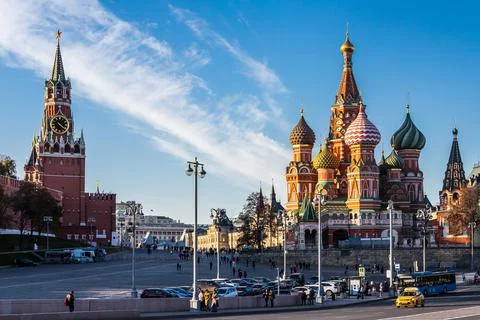 St. Basil's Cathedral and Kremlin Walls and Tower in Red square in sunny blue Stock Photos