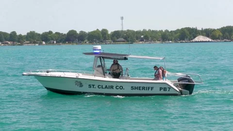 St Clair County Sheriff Boat Cruising Slow, Flashing Blue Lights, St Clair River Stock Footage 343792235