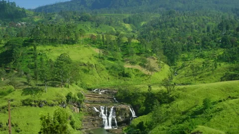 St. Clairs Falls cascading down lush green hills in Sri Lanka Stock Footage 318790056