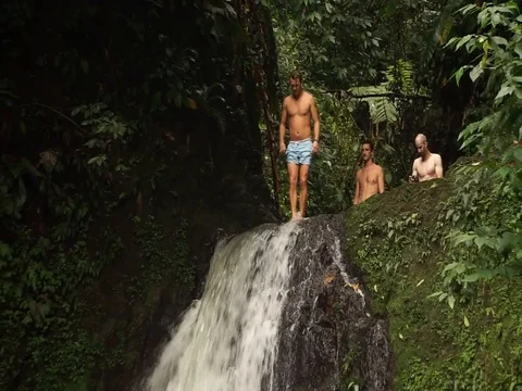 St. George's / Grenada - Nov2016: man jumping off a cliff into a pond. Stock Footage 103456307