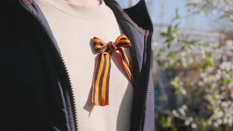 St. George's ribbon on the chest on the jacket in honor of Victory Day on May 9. Stock Footage 278481112