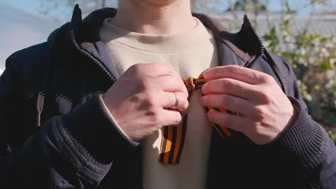 St. George's ribbon on the chest on the jacket in honor of Victory Day on May 9. Stock Footage 278481157