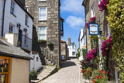 St Ives Cornwall cobbled street with white cottages and granite walls. St Ives Stock Photos