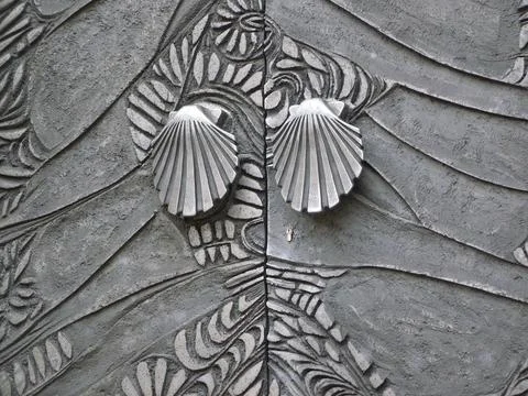 St James way pilgrims shell iron door of a church Stock Photos