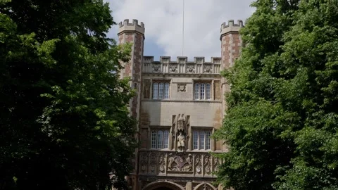St. John s College Gatehouse rising behind green trees in Cambridge, UK Stock Footage 312905916