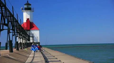 St Joseph river inlet lighthouse. Couple fishing off the pier. 動画素材 12030858