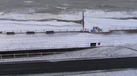 St Leonards, Hastings seafront beach winter snow time lapse Stock Footage 66575937