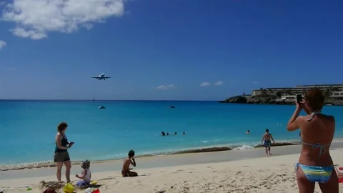 St, Martin plane lands over beach Stock Footage 141018714