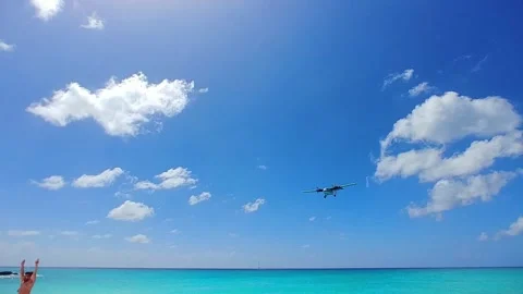 St. martin propeller plane flys over folks Stock Footage 140942994