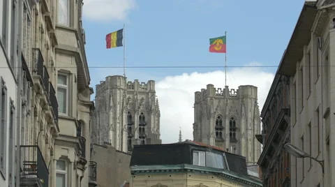 St Michael and St Gudula Cathedral's towers with flags in Brussels Stock Footage 59999519