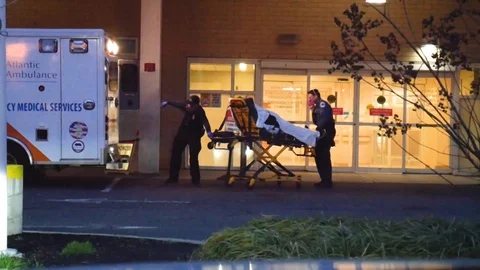 St. Michael's Medical Center Newark NJ Paramedics Pull Gurney Out of Ambulance Stock Footage