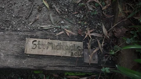 St. Michaels plaque on a wooden step surrounded by leaves Stock Footage 341908725
