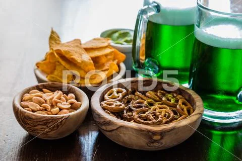 St Patrick day party - green beer and appetizers Stock Photos
