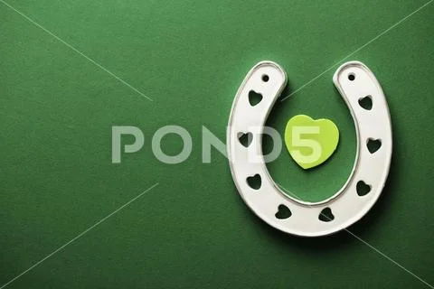St Patrick's Day green background with lucky horseshoe Stock Photos
