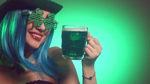 St. Patrick's Day. Leprechaun model girl with pint of green beer  Stock Footage 102632966
