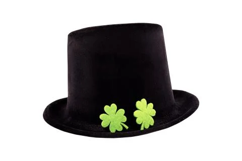 St. Patrick's Day pattern black hat on the fields lies a pair of green clover Stock Photos
