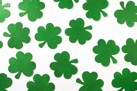 St. Patrick's day pattern with clover leaves on white . Stock Photos