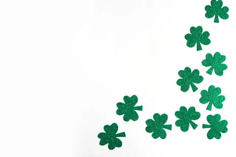 St. Patrick's Day side border paper shamrocks on white background. Copy space Stock Photos