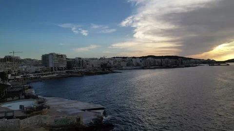 St. Paul's Bay Bugibba at sunset with cloud aerial Stock Footage 264917093