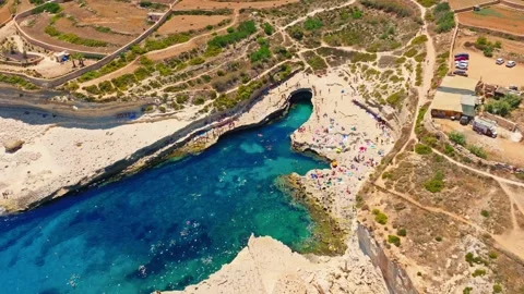St. Peter's Pool on summer. Drone view, people swimming, beach. Malta island Stock Footage 312382872