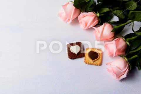 St. Valentine's Day background with five pink roses and cookies Stock Photos