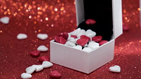 St. Valentine's day gift box full of candies on glitter red background. Stock Footage 146298859