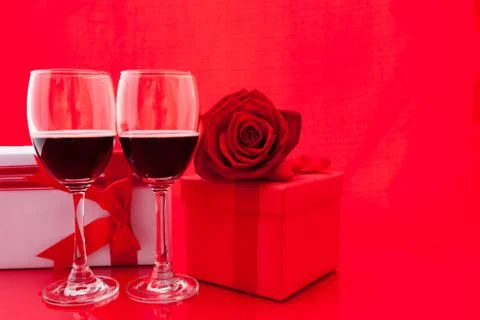 St Valentine's setting with present and red wine Stock Photos