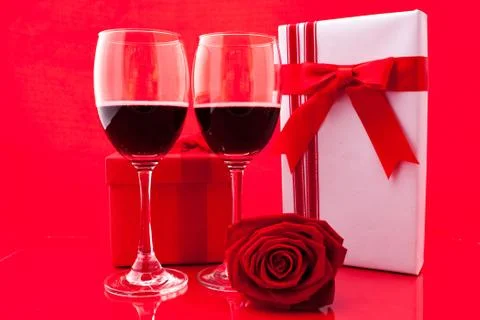 St Valentine's setting with present and red wine Stock Photos