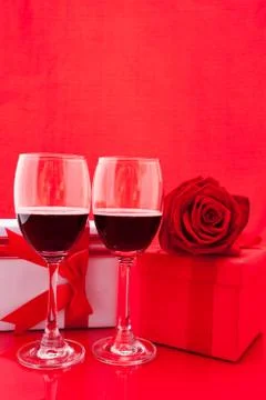 St Valentine's setting with present and red wine Stock Photos