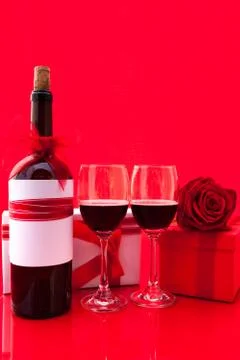 St Valentine's setting with present and red wine Stock Photos