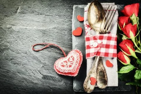 St Valentine's table setting with red roses and decorative hearts Stock Photos