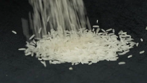 ST25 Rice Falling Slow Motion On Black Background Close Up Stock Footage 325019680