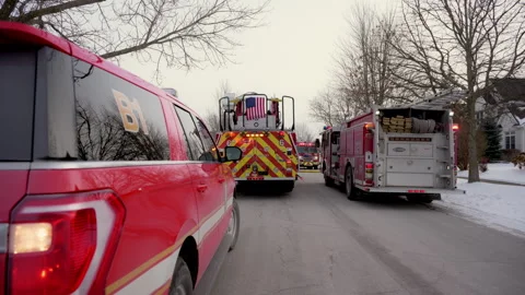 Stabile shot of fire emergency vehicles on the city street. Rear view Stock Footage 310631280