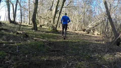 Stabilised shot of men trail running in the forest 動画素材 112006235