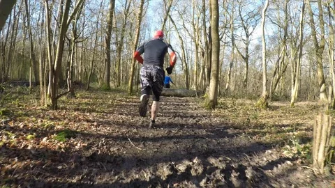 Stabilised shot of men trail running in the forest Stock Footage 112006325