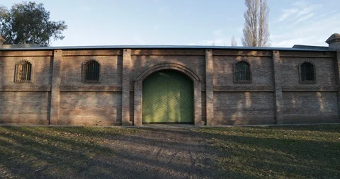 Stabilized camera motion of big brick construction at sunset golden hour 스톡 동영상 91709515