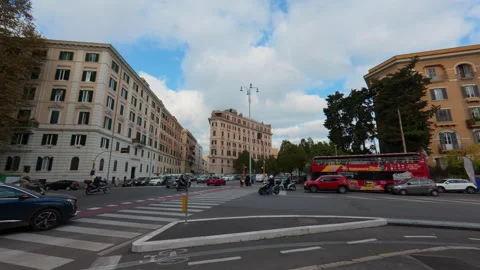 Stabilized forward walk through busy city intersection with cars, scooters, and Stock Footage 322116664