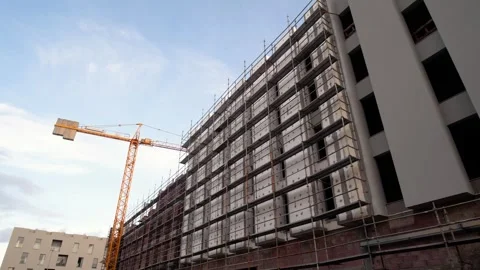 Stabilized Gimbal Shot of Construction Site with Tower Crane and Stock Footage 262309717