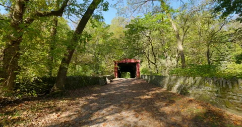 Stabilized Gimbal Shot Red Covered Bridge in Woods at Wissahickon Creek Stock Footage 142006104